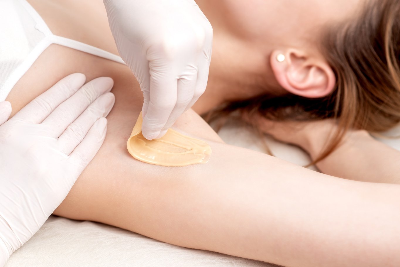 Cosmetologist Applying Wax Paste on Armpit